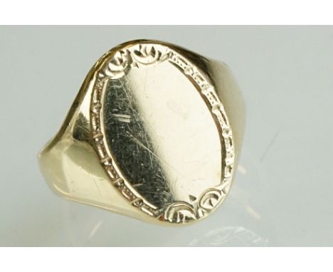 9ct yellow gold signet ring, oval plain polished head with decorative surround, dimensions approx 19mm x 14mm, tapered should