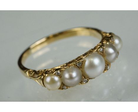 Pearl and diamond five stone yellow metal ring, five graduated split pearls, eight small rose cut diamond accents, open and c