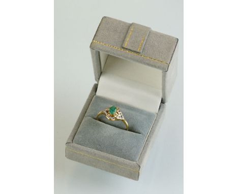 Emerald and cubic zirconia 14ct yellow gold ring, the oval mixed cut emerald measuring approx 5.5mm x 4mm, claw set, twenty s