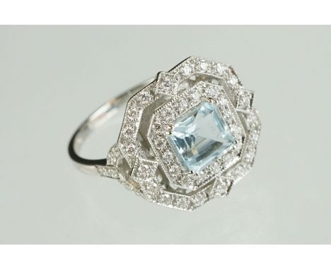 Aquamarine and diamond 18ct white gold halo ring, the square step cut aquamarine measuring approx 6mm x 6mm, small round bril