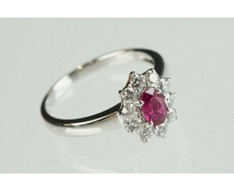 Ruby 18ct white gold cluster ring, the oval mixed cut ruby measuring approx 6mm x 3.5mm, claw set, ten round brilliant cut di