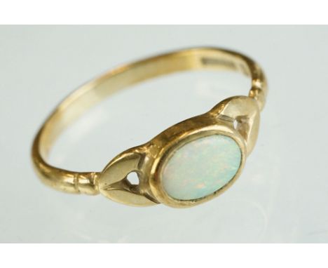 Opal 9ct yellow gold ring, oval cabochon cut precious white opal displaying green and orange play-of-colour, dimensions appro