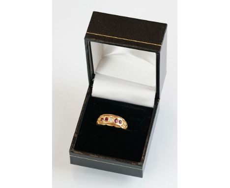 Edwardian diamond and ruby 18ct yellow gold ring, the central round old cut diamond weighing approx 0.05 carat, two small ova