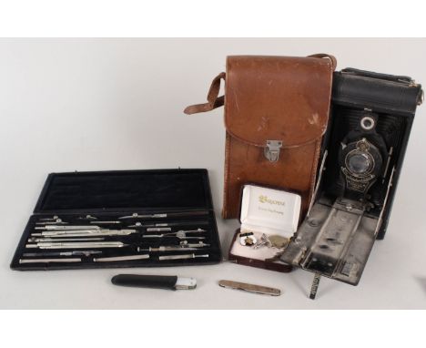 A cased vintage Kodak camera, silver body pen knife, cufflinks, a compass set plus a mother of pearl knife