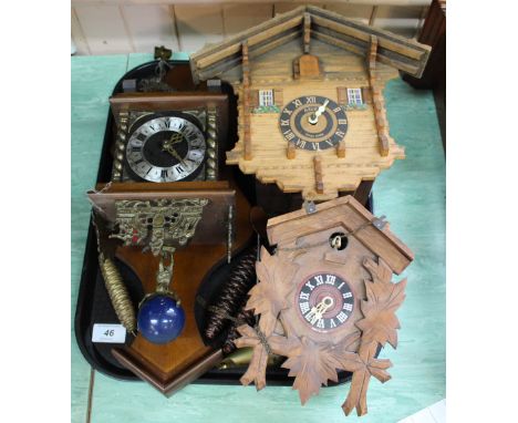 A German and a Swiss cuckoo clock plus another continental wall clock