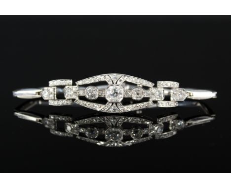 A precious metal Art Deco style diamond set bracelet, the central stone (approx 0.7cts) in octagonal shaped setting with two 