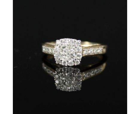 A 9ct gold diamond cluster ring with raised setting, size K