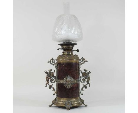 An ornate 19th century brass mounted hardstone oil lamp, with scrolled mounts and an etched and moulded glass shade, stamped 