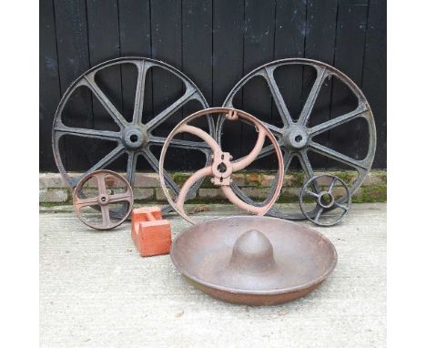 A pair of iron cart wheels, together with three others smaller, an iron weight and a pig trough