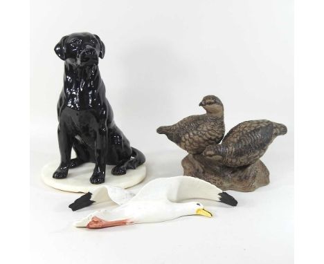 A Beswick fireside pottery model of a seated labrador, 2314, 34cm high, on a slate base, together with a Poole pottery group 