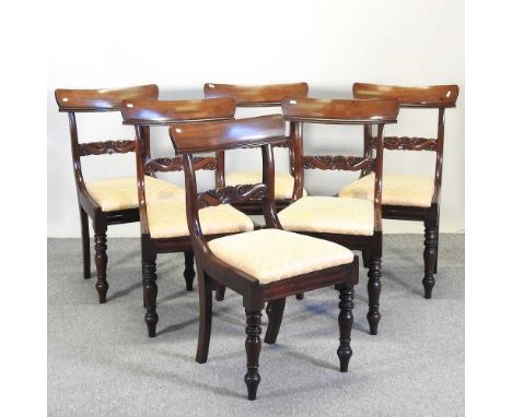 A set of six William IV mahogany dining chairs, each having a curbed bar back, with a scroll carved horizontal splat and yell