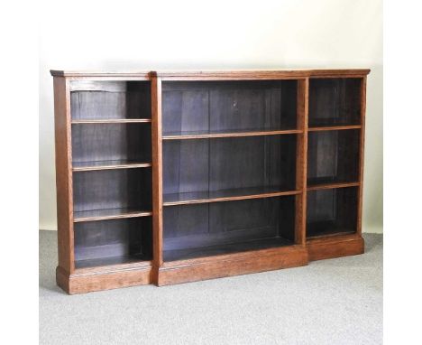 A Victorian light oak dwarf breakfront open bookcase, with adjustable shelves, on a plinth base218w x 32d x 131h cm