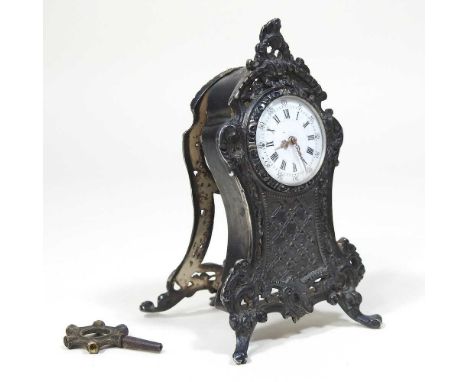 An early 20th century silver miniature bracket clock, having a white enamel dial, within a scrolled surround, 9cm high