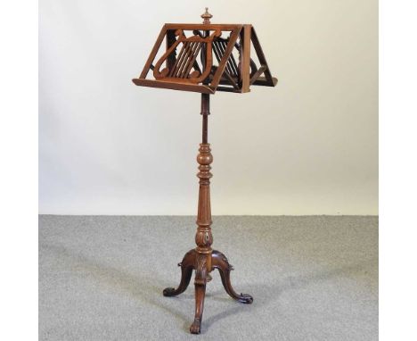 An early 20th century carved walnut duet stand, with an adjustable top, on a fluted column and tripod baseCondition report: O