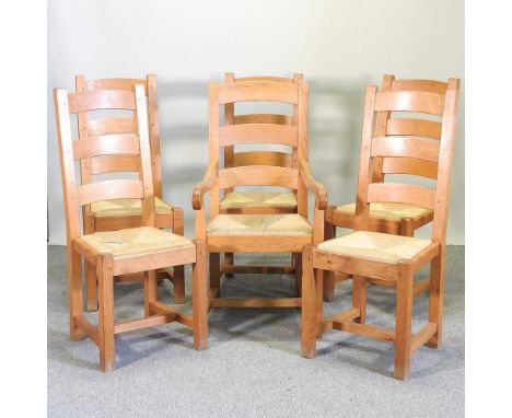 A set of six light oak ladder back dining chairs, with rush seats