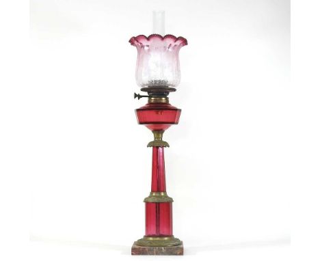 A 19th century Irish ruby glass oil lamp, inscribed patented Arc and Lamp, D Sheehan, 109 &amp; 110 Patrick Street, Cork, wit