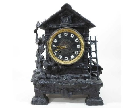 A 19th century continental cast metal mantel clock, in the form of a chalet, decorated with ivy, the twin train movement stri