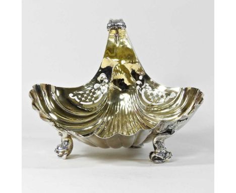 An early 20th century gilt fruit dish, of shell shape, with a gilt interior and pierced decoration, on three dolphin feet, st