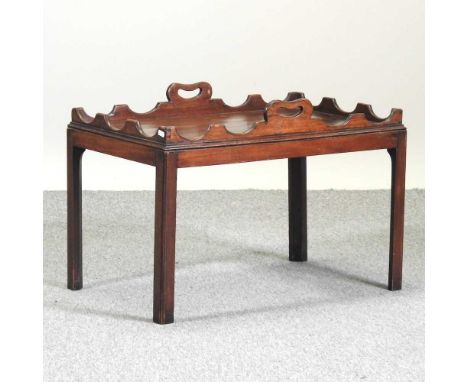A mahogany butler's tray, with a shaped gallery70w x 46d x 50h cmCondition report: Overall is solid and usable. Has various l