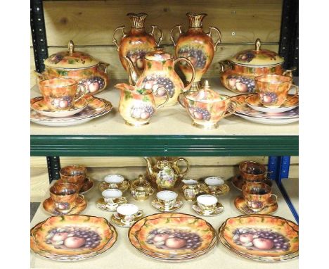 A Marquis bone china tea and dinner service, decorated with fruit by D. Hague, to include tureens, together with a continenta