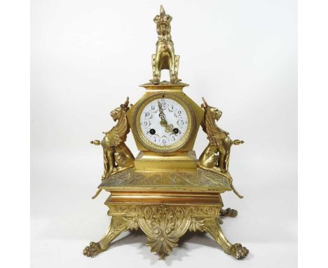 An unusual 19th century ormolu mantel clock, in the Chinese taste, surmounted by a temple dog, flanked by winged beasts, on l