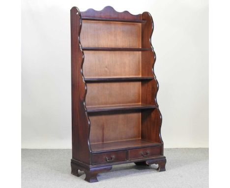 A reproduction mahogany waterfall bookcase, on bracket feet, 78cm