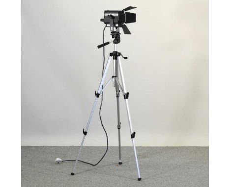 A vintage Italian Mini Fresnel spotlight, 24cm long, mounted on a camera tripod