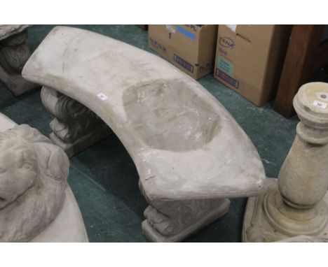 Bow shaped garden bench on decorative supports