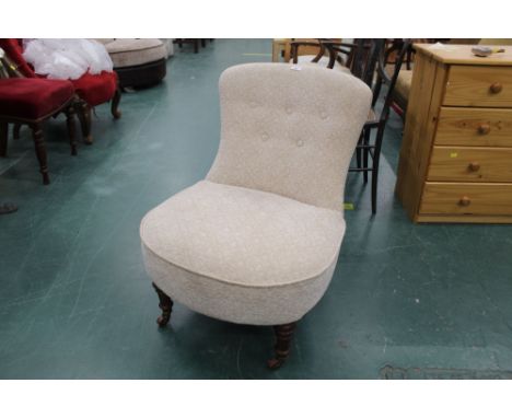 Small button back bedroom chair in fleur de lis upholstery with turned legs on castors