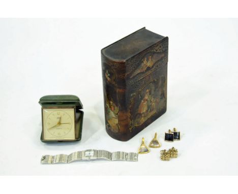 A papier mache box in form of a book filled with costume jewellery, travel alarm clock etc