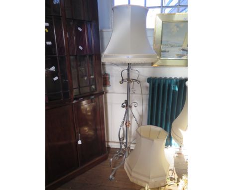 A Victorian brushed wrought metal and copper standard lamp, converted into electricity, with scrolling tripod base 130cm high