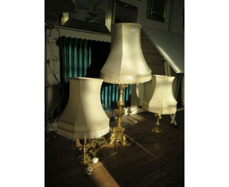 A pair of turned brass table lamps and a carved giltwood table lamp