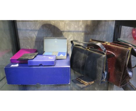 A black snakeskin handbag by Mappin &amp; Webb, another handbag by Elbief, a Mappin &amp; Webb leather wallet, an Aspreys set