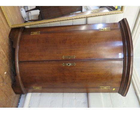 A George III mahogany bowfront corner cupboard, the later top over bowed doors on later bracket feet, 69cm wide 105cm high