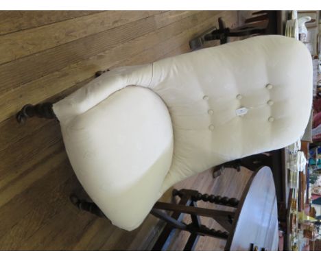 A late Victorian stained beech nursing chair, the button back and padded seat on turned tapering legs and pot castors
