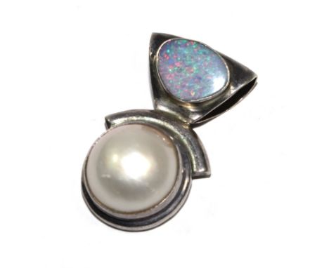 An opal and pearl pendant set in silver