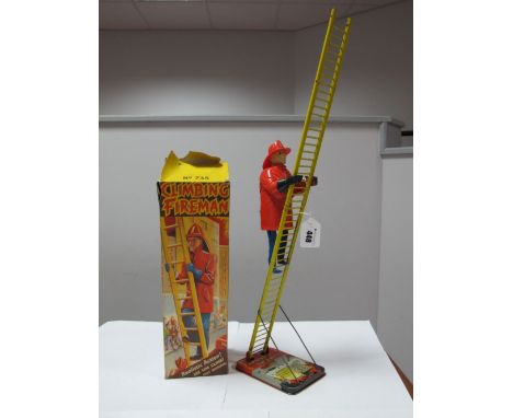 A Mid XX Century "Climbing Fireman" by Marx of Great Britain. Plastic clockwork fireman in an American style with metal ladde