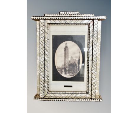 A monochrome picture in ornate mother of pearl effect frame 36 cm x 47 cm