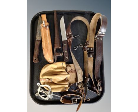 Two hunting style knives in leather sheaths, leather pouch, belts 