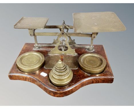A large set of 19th century brass and oak postal scales with weights, width 42 cm 