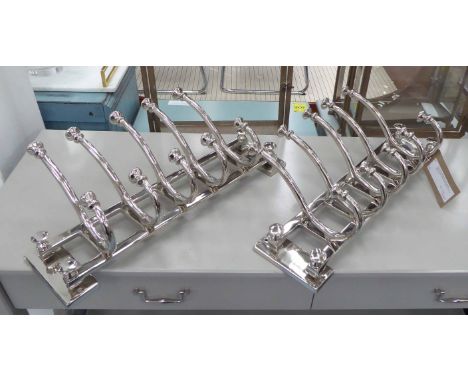 WALL COAT HANGERS, a pair, silvered chromed metal contemporary design, 27cm H x 59cm L. (2)