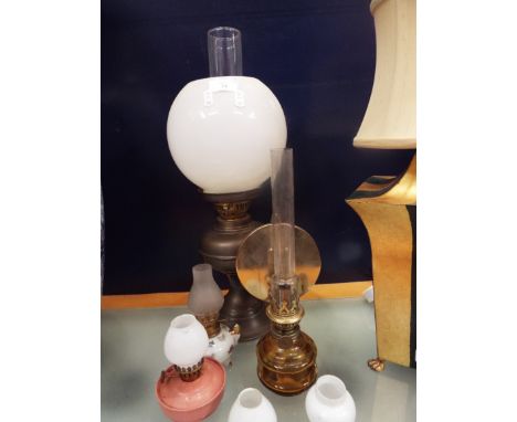 A selection of brass, glass and a ceramic oil lamp