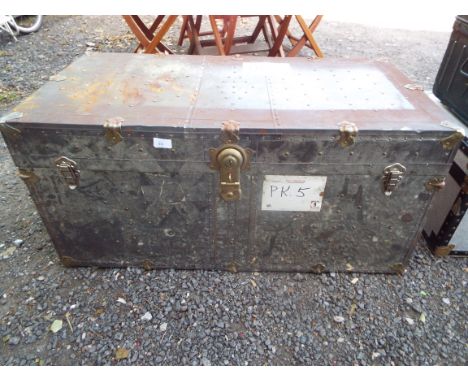A tin and brass bound shipping trunk
