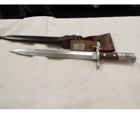 A Swiss WWI bayonet stamped 'Waffenfabrik Neuhausen No. 111165', complete with steel and leather scabbard, the ball tip stamp