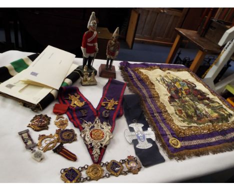A box of Masonic items to include sash, medals medallions and two plaster soldiers 