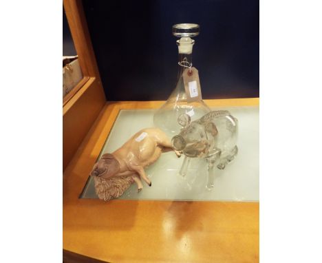 A glass gin pig decanter, an Orrefors style ship's decanter and a model of a sleeping sow