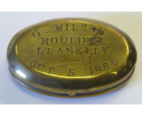 A Victorian Brass Oval Snuff Box, the hinged cover stamped G. WILSON. MOULDER LLANELLY OCT. 5. 1889 and decorated with a smok