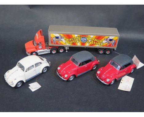 A Franklin Mint 1:43 Scale Mack Truck and Trailer 'Ringling Bros' and Three 1:24 Volkswagen Beetle. All have been displayed a