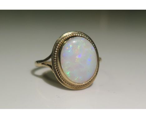 A 9ct Yellow Gold and White Opal Dress Ring, 7x9mm stone, size O, 2.1g 