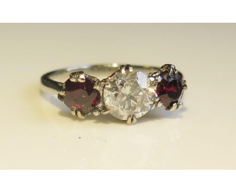 A Platinum, Ruby and Diamond Three Stone Ring, size H.5, 3g. EDW .8ct, rubies 4.5 and 4mm 